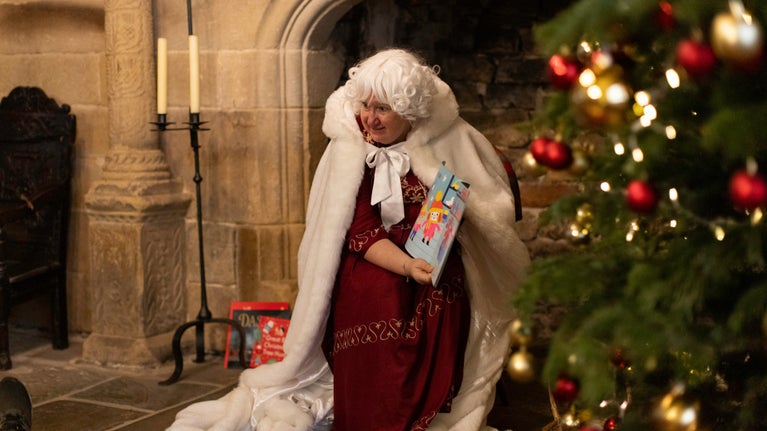 Mrs Claus storytelling in the Great Hall, East Riddlesden Hall, Yorkshire